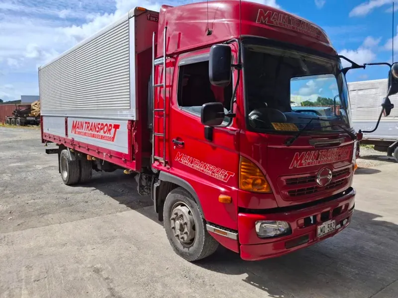 Red Main Transport Hino truck with an aluminium side body, parked at the Suva depot